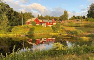 a house on a hill next to a lake at Lovely Home In Örkelljunga With Sauna in Orkelljunga