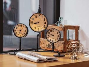 three clocks sitting on top of a table at Mercure Paris Centre Gare Montparnasse in Paris