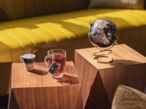a table with two cups and a magnifying glass at Mercure Paris Centre Gare Montparnasse in Paris +186 photos