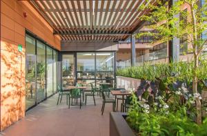 an outdoor patio with tables and chairs in a building at Staybridge Suites - Guadalajara Novena by IHG in Guadalajara