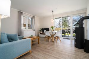 a living room with a blue couch and a table at Strandhaus-3-EG in Marienfelde