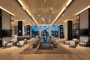 a lobby with a table and chairs in a building at Crowne Plaza Wuzhen by IHG in Tongxiang