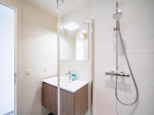 a bathroom with a shower and a sink at Spacious City Retreat with Balcony in Antwerp