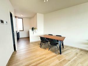 a dining room with a wooden table and chairs at Spacious City Retreat with Balcony in Antwerp