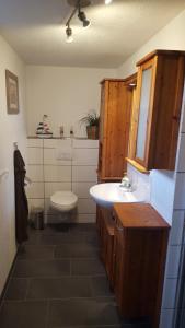 a bathroom with a sink and a toilet at Ferienwohnung Rinno in Olbernhau