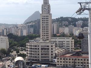 a tall building with a clock tower in a city at Casa lai in Rio de Janeiro