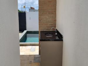 a kitchen with a sink and a swimming pool at 01 - Saint Marie Beach House in Conde