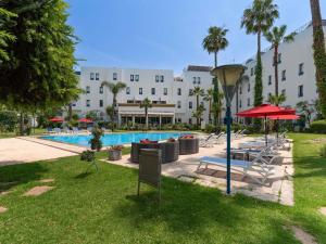 a hotel with a swimming pool and a resort at Ibis Fes in Fez