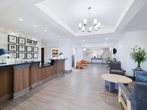 a lobby of a clinic with a table and chairs at Garner Hotel Longview South by IHG in Longview +87 photos