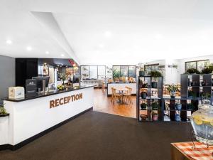 a reception area of a store with a reception counter at ibis Thornleigh in Thornleigh