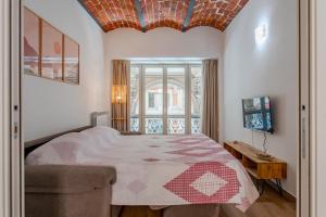 a bedroom with a large bed and a window at Royal Apartment by Toh Solution in Turin