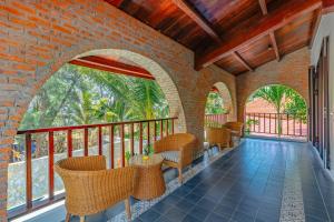 an outdoor patio with chairs and tables and windows at Salt Villa 5BR Beachfront by HUA in An Bàn (2)