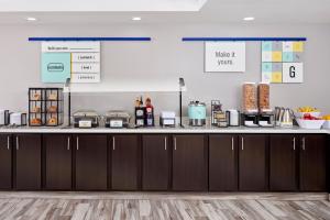 a kitchen with a counter with some food on it at Garner Hotel Virginia Beach North by IHG in Virginia Beach