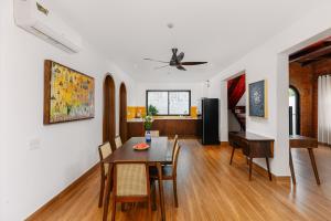 a dining room and living room with a table and chairs at Salt Villa 5BR Beachfront by HUA in An Bàn (2)