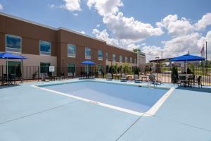 a large swimming pool in front of a building at Holiday Inn Express Wilson I-95 by IHG in Wilson