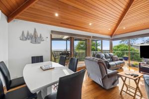 a living room with a table and chairs and a dining room at Blue Water - BYO Linen in Anglesea