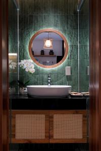 a bathroom with a sink and a mirror at May Home Apartment Da Nang in Danang +60 photos