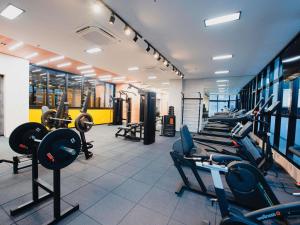 a gym with a bunch of treadmills and machines at ibis Curitiba Shopping in Curitiba