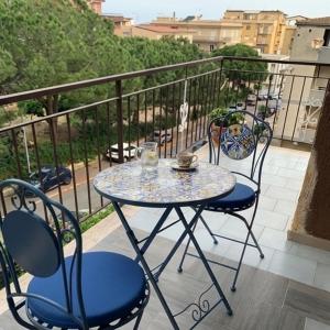 a table and chairs sitting on a balcony at B&B Salty Mermaid in Tropea