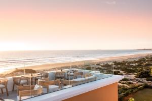a view of the beach from the balcony of a house at Palacio de Sancti Petri, a Gran Meliá Hotel - The Leading Hotels of the World in Chiclana de la Frontera