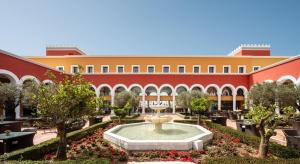 a courtyard with a fountain in front of a building at Palacio de Sancti Petri, a Gran Meliá Hotel - The Leading Hotels of the World in Chiclana de la Frontera +175 photos
