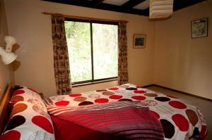 a bed in a room with a large window at 40 Aireys Street in Aireys Inlet