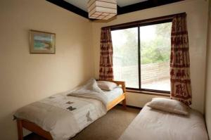 a bedroom with a twin bed and a window at 40 Aireys Street in Aireys Inlet