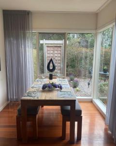 a table in a living room with a large window at Aireys Oasis in Aireys Inlet