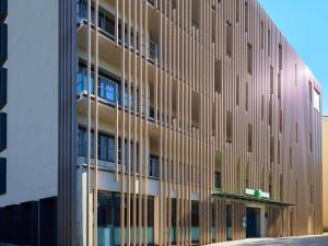an external view of a tall building with windows at ibis Styles Montelimar Centre in Montélimar