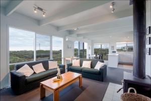 a living room with two couches and a fireplace at Moggs View in Aireys Inlet +2 photos