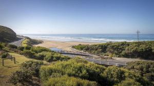 a road next to a beach next to the ocean at Moggs View in Aireys Inlet