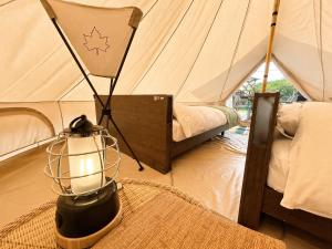 a room with a tent with a lantern and a table at 瀬戸内リゾートベッセルおおち in Higashikagawa +45 photos