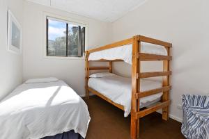 a bedroom with two bunk beds and a ladder at Mirimar in Apollo Bay