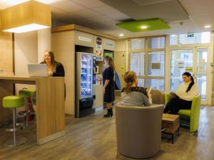 a group of people in a waiting room in a hospital at Hotel ibis budget Aix Les Bains - Grésy in Grésy-sur-Aix