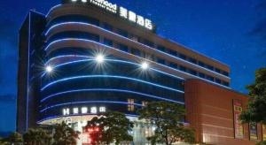 a building with lights on the side of it at MAIHAOHOTELS in Huangdong