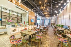 a restaurant with tables and chairs and a counter at MAIHAOHOTELS in Huangdong