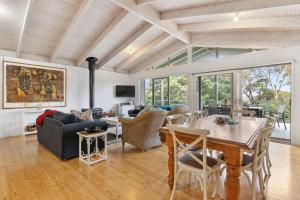a living room with a table and a dining room at Coastwalk in Aireys Inlet
