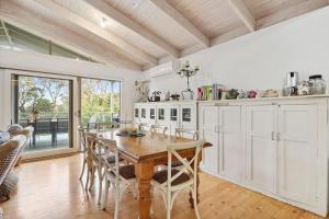 a kitchen with a wooden table and chairs at Coastwalk in Aireys Inlet