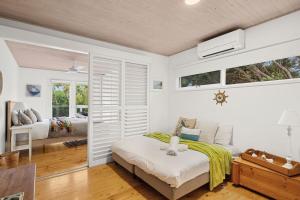 a bedroom with a bed and a living room at Coastwalk in Aireys Inlet