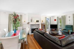 a living room with a glass table and a couch at Noble Villa - BYO Linen in Anglesea