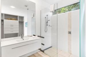 a white bathroom with a sink and a shower at Drift - Luxury, location and ocean views in Wye River +13 photos
