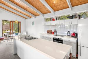 a kitchen with white cabinets and a white counter top at Fairhaven Escape in Aireys Inlet