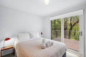a bedroom with a bed and a large window at Fairhaven Escape in Aireys Inlet +5 photos