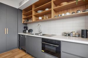 a kitchen with a sink and a stove at Hakea Ridge in Aireys Inlet