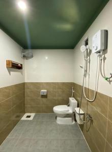 a bathroom with a toilet and a shower at Xóm Chài Homestay in Thôn Sơn Hải