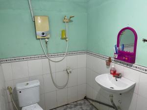 a bathroom with a shower and a toilet and a sink at Nam Binh Homestay in Ben Tre +158 photos