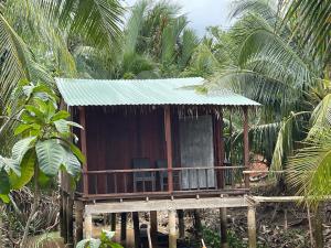 a small house in the middle of a forest at Nam Binh Homestay in Ben Tre