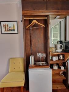 a yellow chair and a refrigerator in a kitchen at Room at Lindley in Ludlow