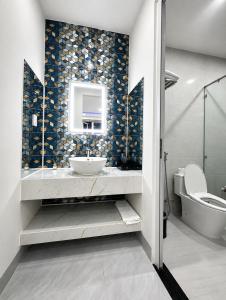 a bathroom with a sink and a toilet and a mirror at Lêu Hêu Villa & Coffee in Thôn Mỹ Phước +19 photos