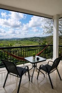 a balcony with a table and chairs and a view at Payas Private Farm Villa in Praya